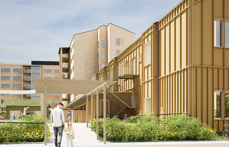 En pappa och en flicka som går in på förskolan, en byggnad i trä med en paviljong framför