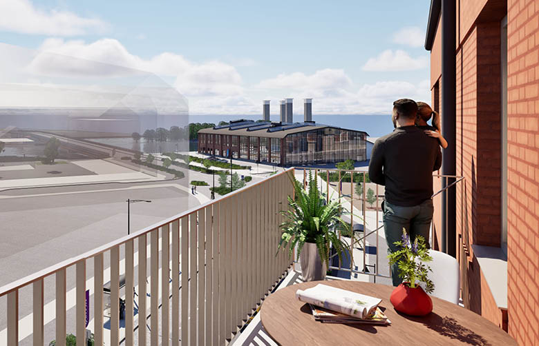 Pappa som står på en balkong med sitt barn i famnen och tittar ut mot den gamla filfabriken och kanalen